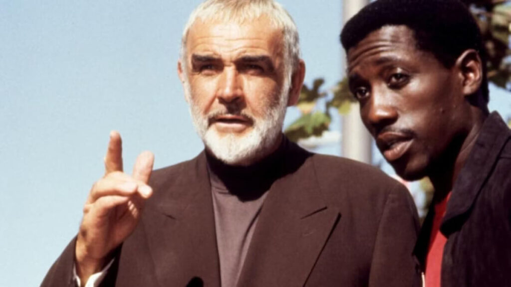 2 men look towards the camera.